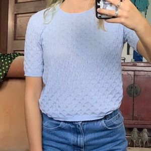 Blue knitted top.